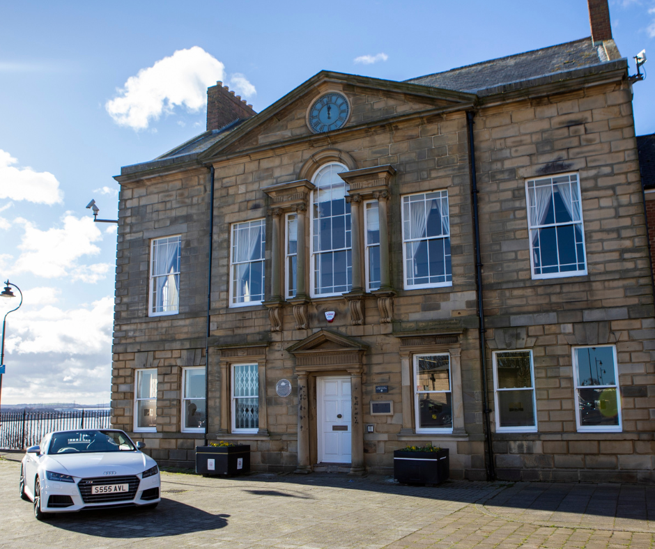 Old stone building with white car outside