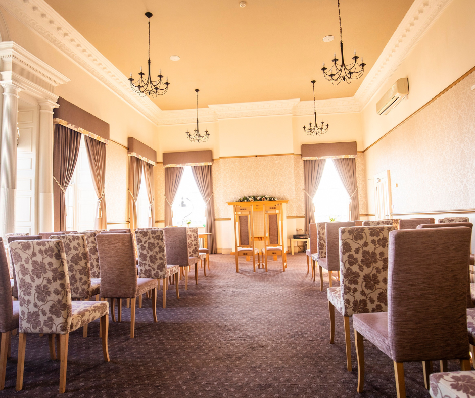 chairs down the side of an aisle with a table at the end