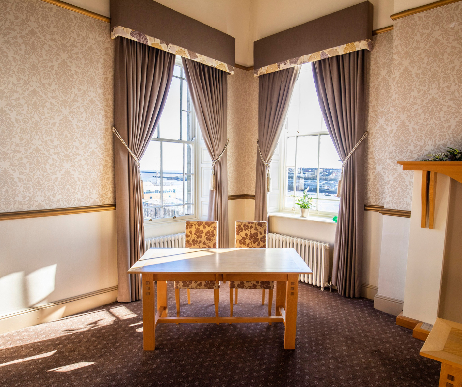 table in a window with curtains
