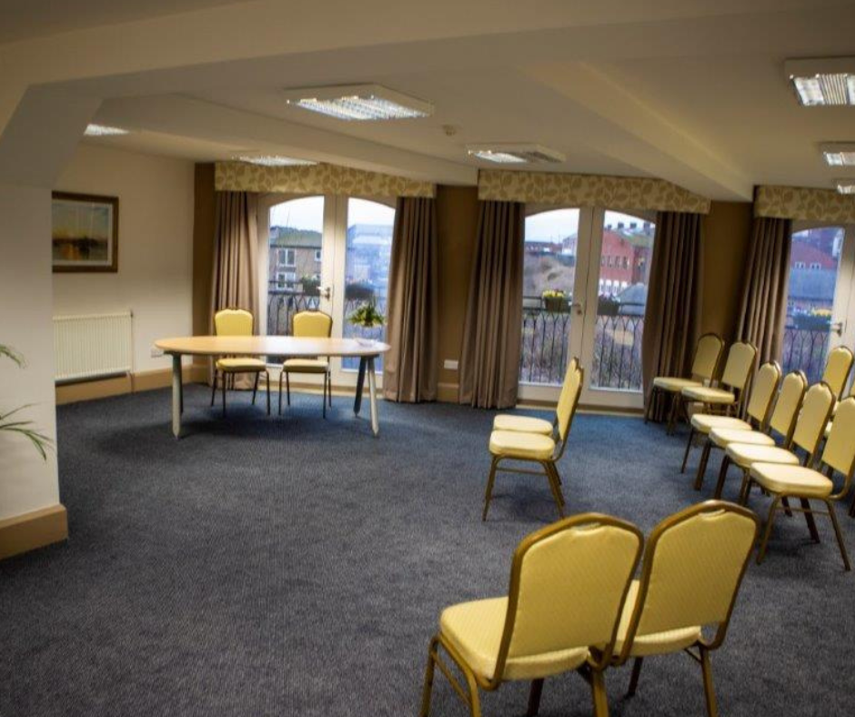 chairs in a room pointing towards a desk