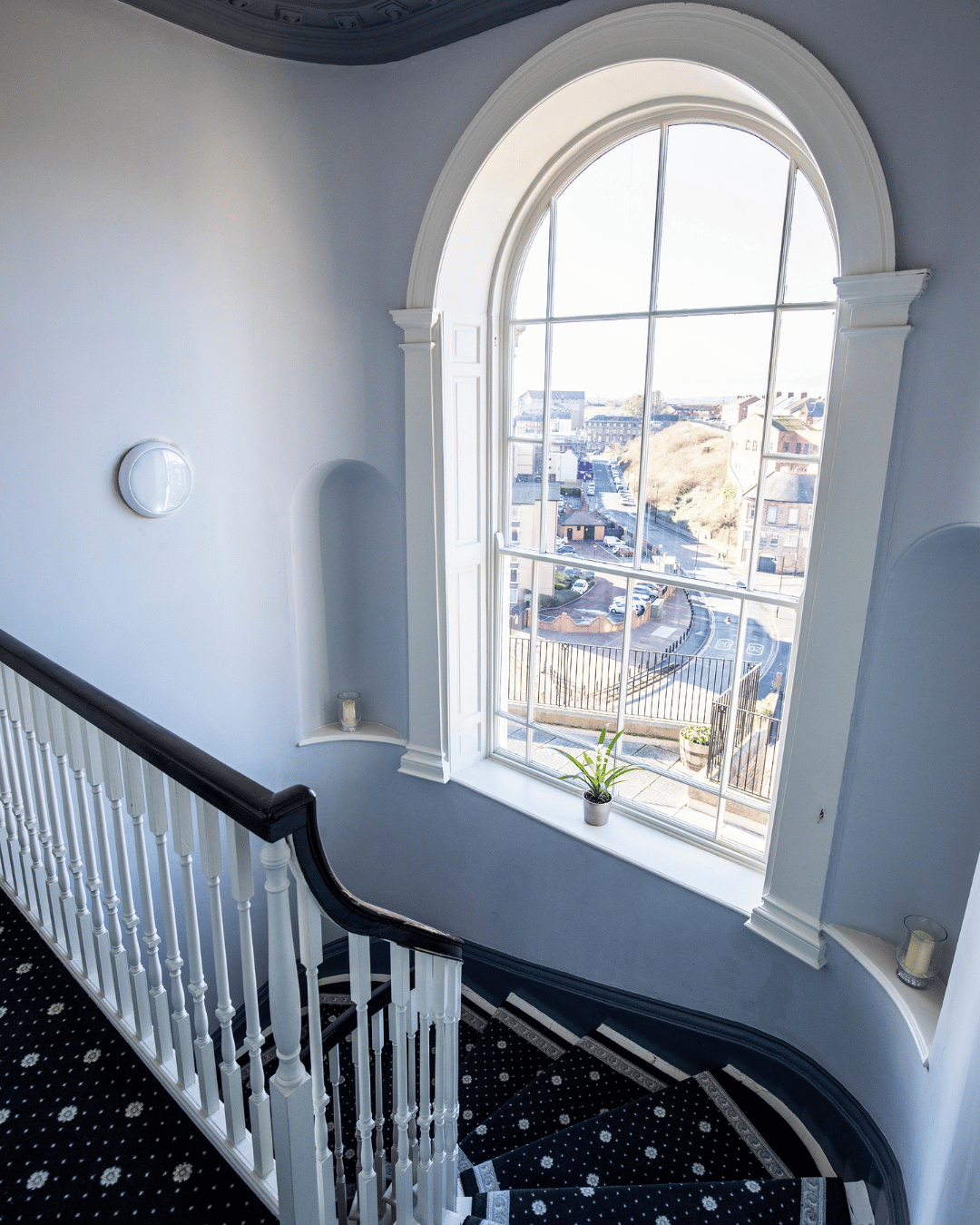 large arched window on a stairwell