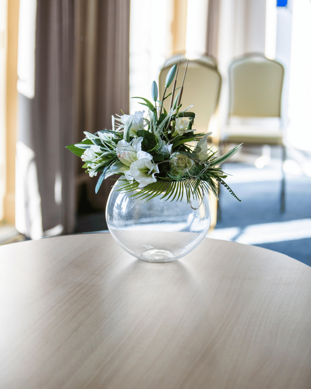 vase on a table with flowers in