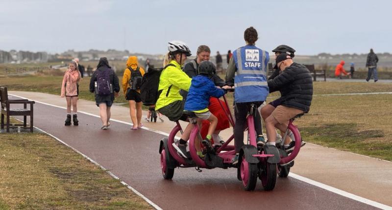 Multiple people on an adapted bike at Whitley Bay
