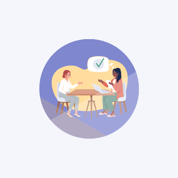 Two people sat at a table conducting a job interview.