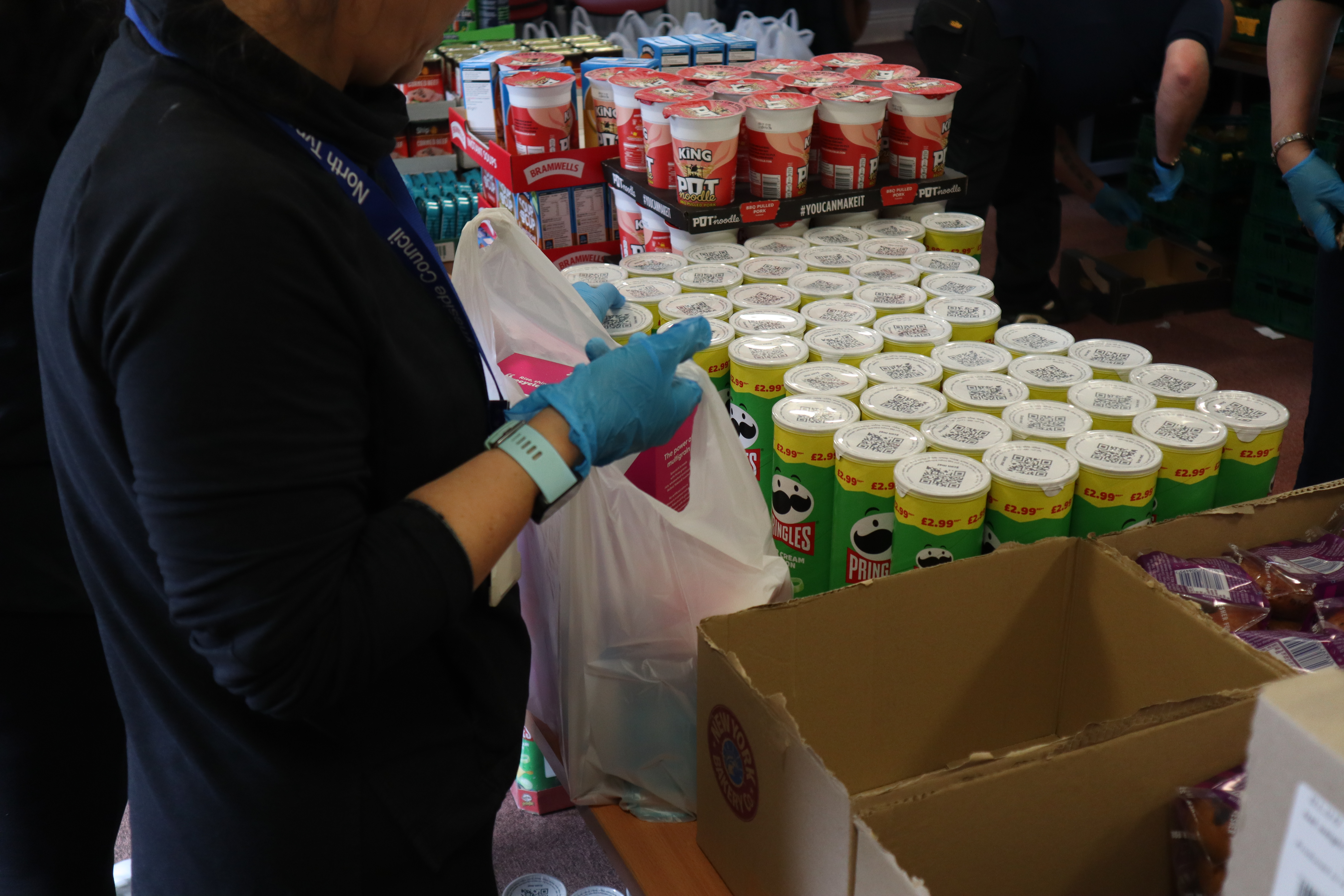 Person packing groceries at food bank