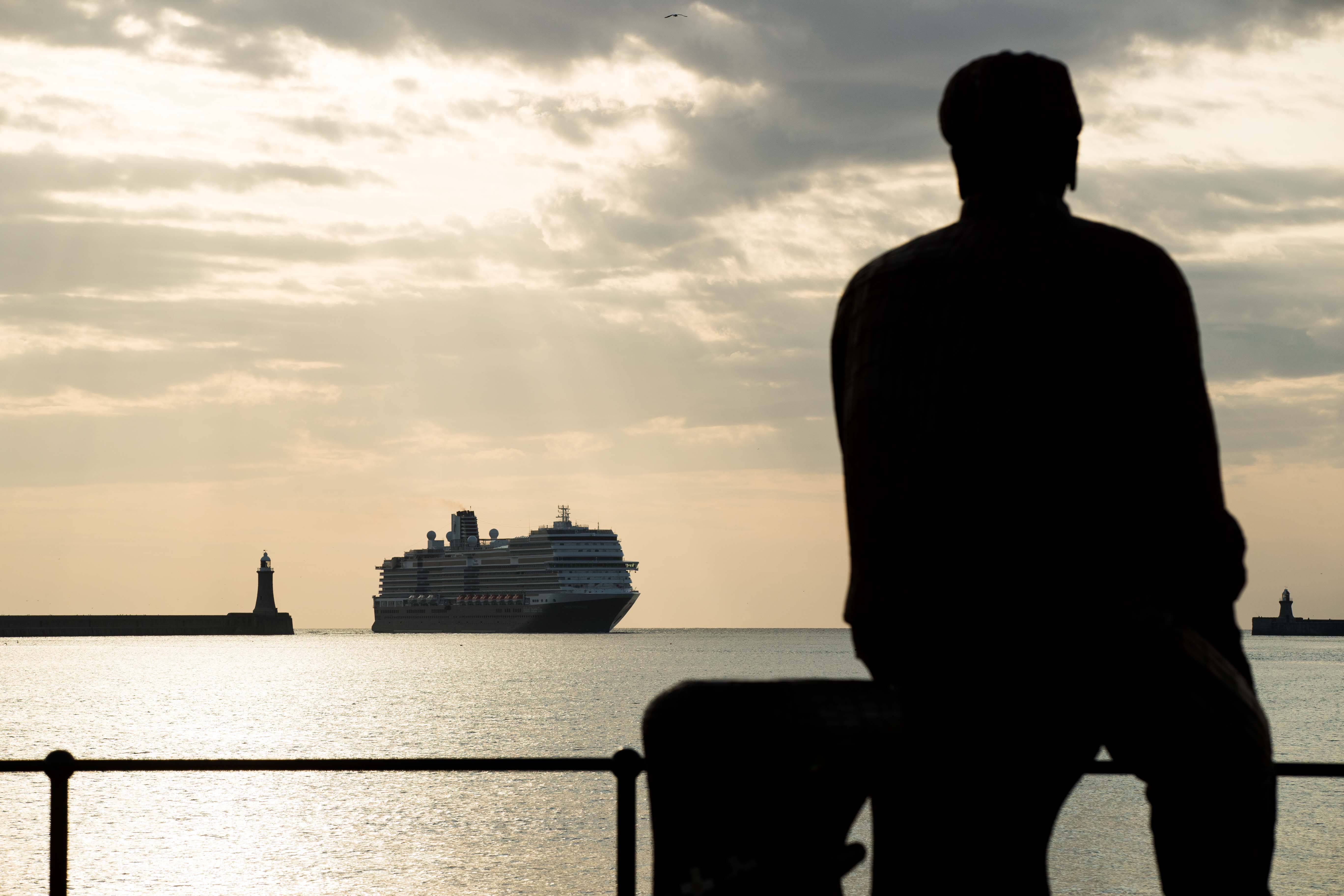 Silhouette of fisherman sculpture looking out over the mouth of the river tyne.