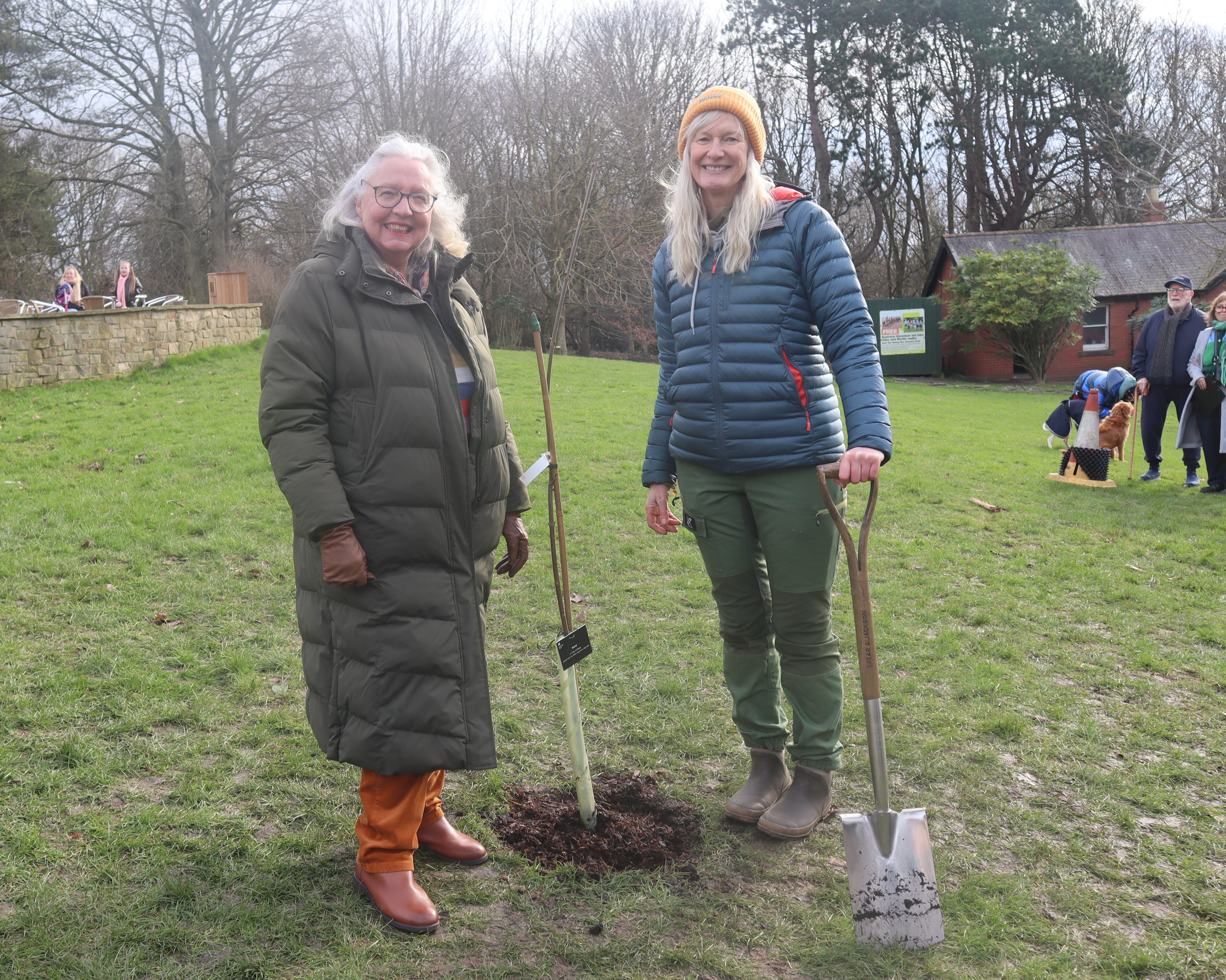 Cllr Sandra Graham and Cath Darling pose next to the Sycamore Gap tree sapling which was just planted in Rising Sun Country Park