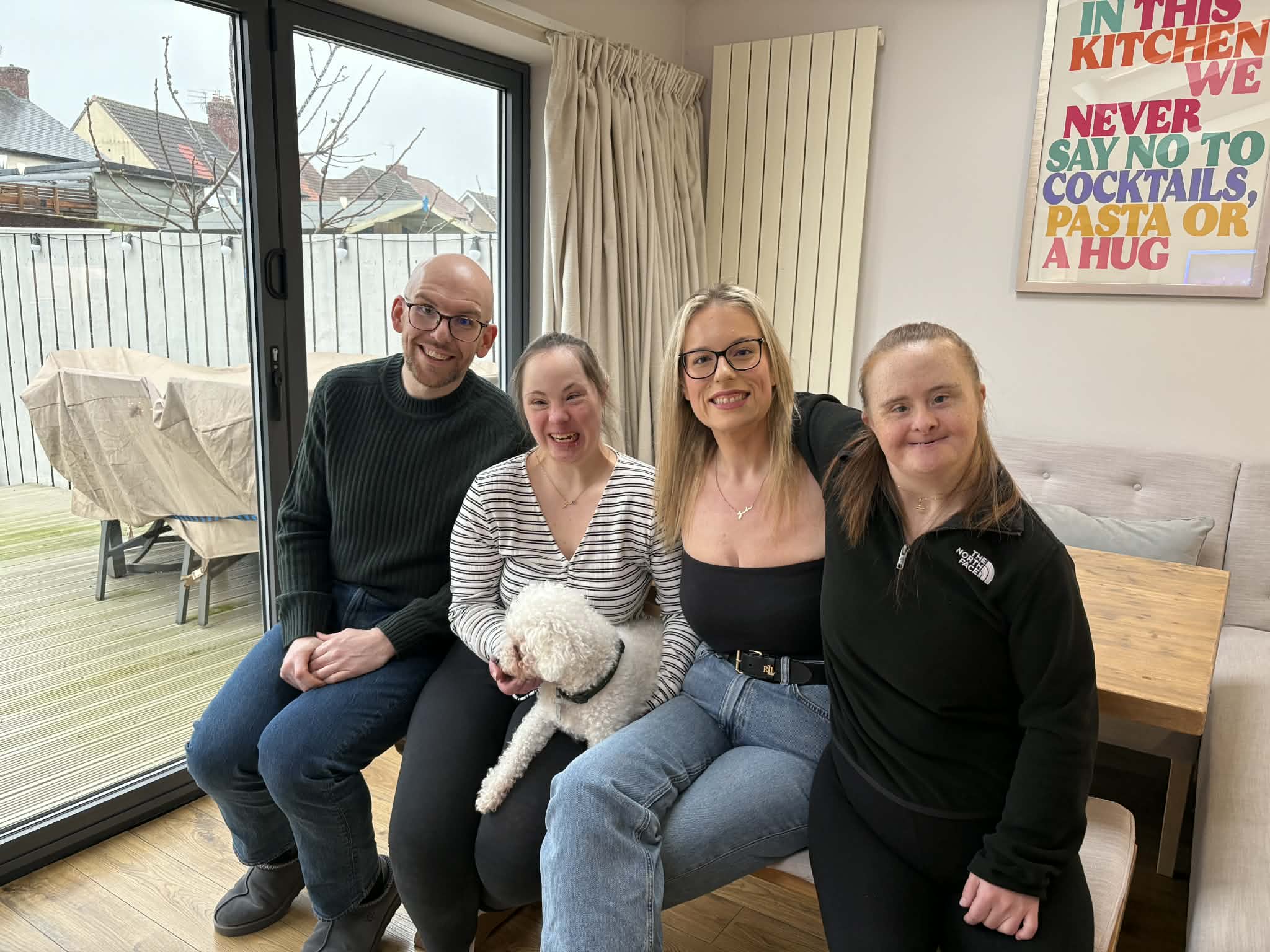 Adam, Jo, Jade and Lisa pictured on a bench in their home. 
