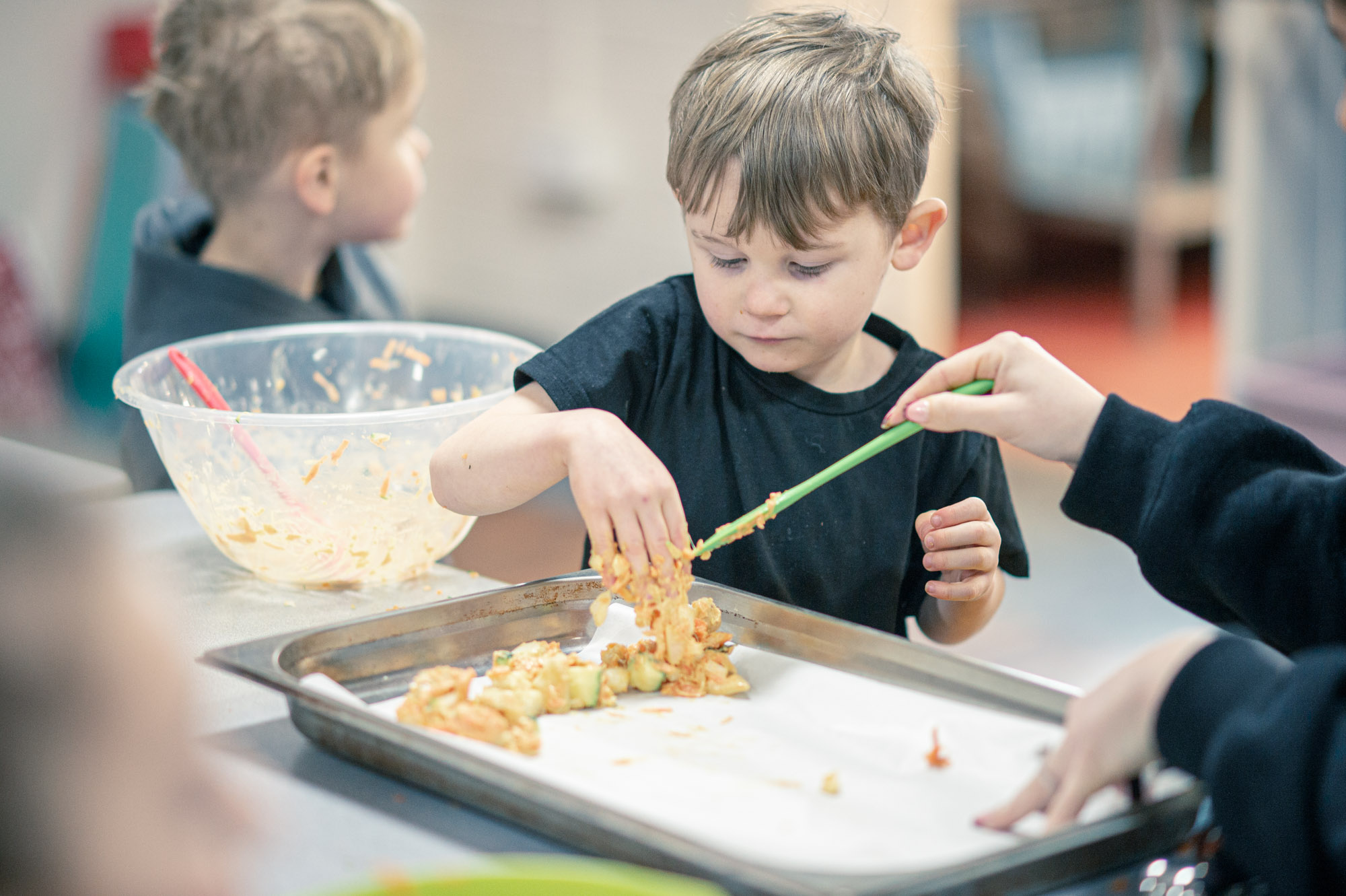 Children making food on a baking tray