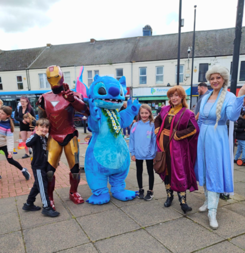 Image of people in character costumes and children