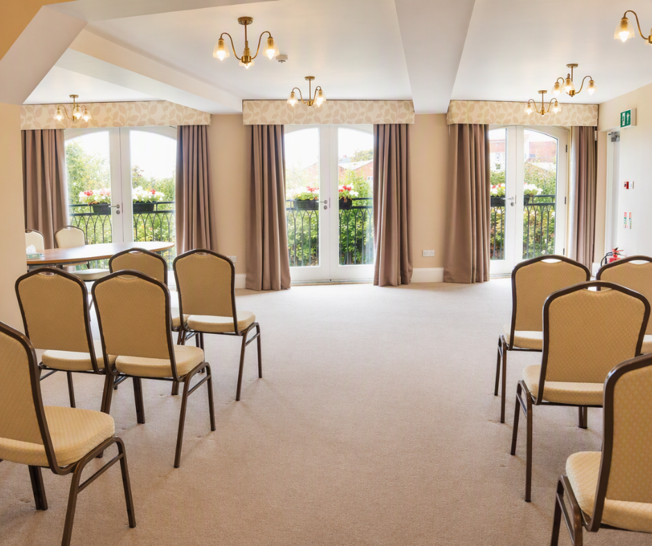Rows of chairs in a neautral room set up for a wedding