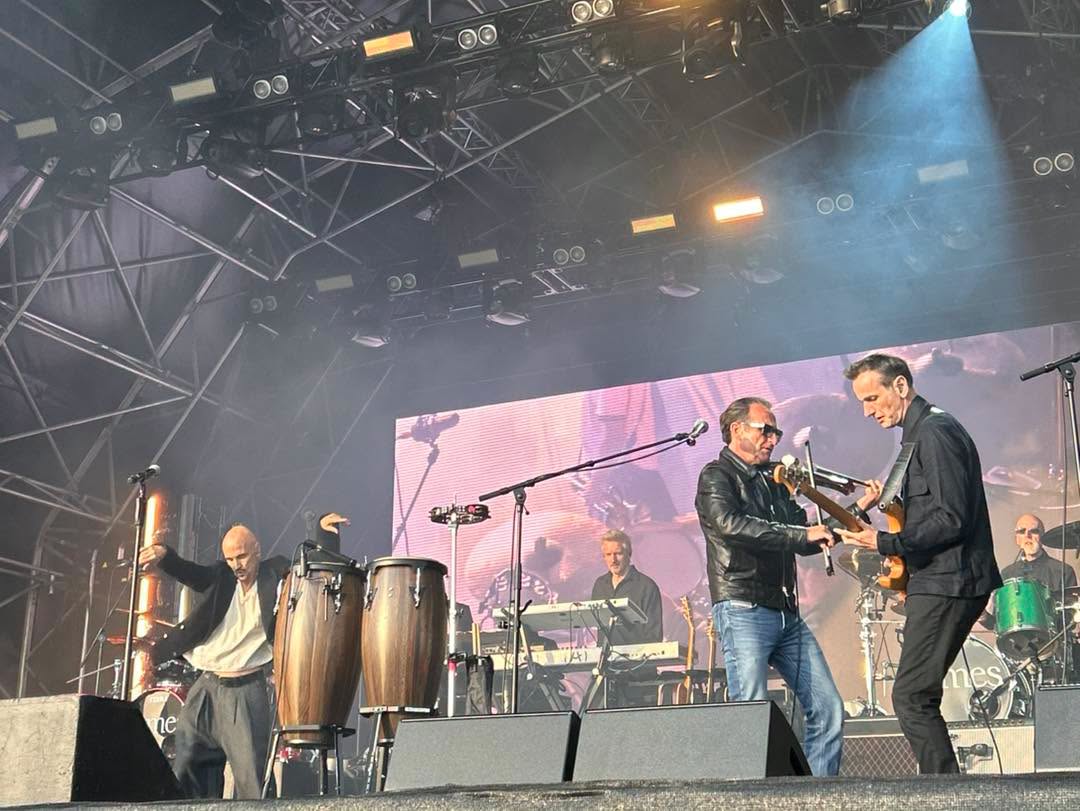 Artists performing under the vibrant Mouth of the Tyne stage lights.