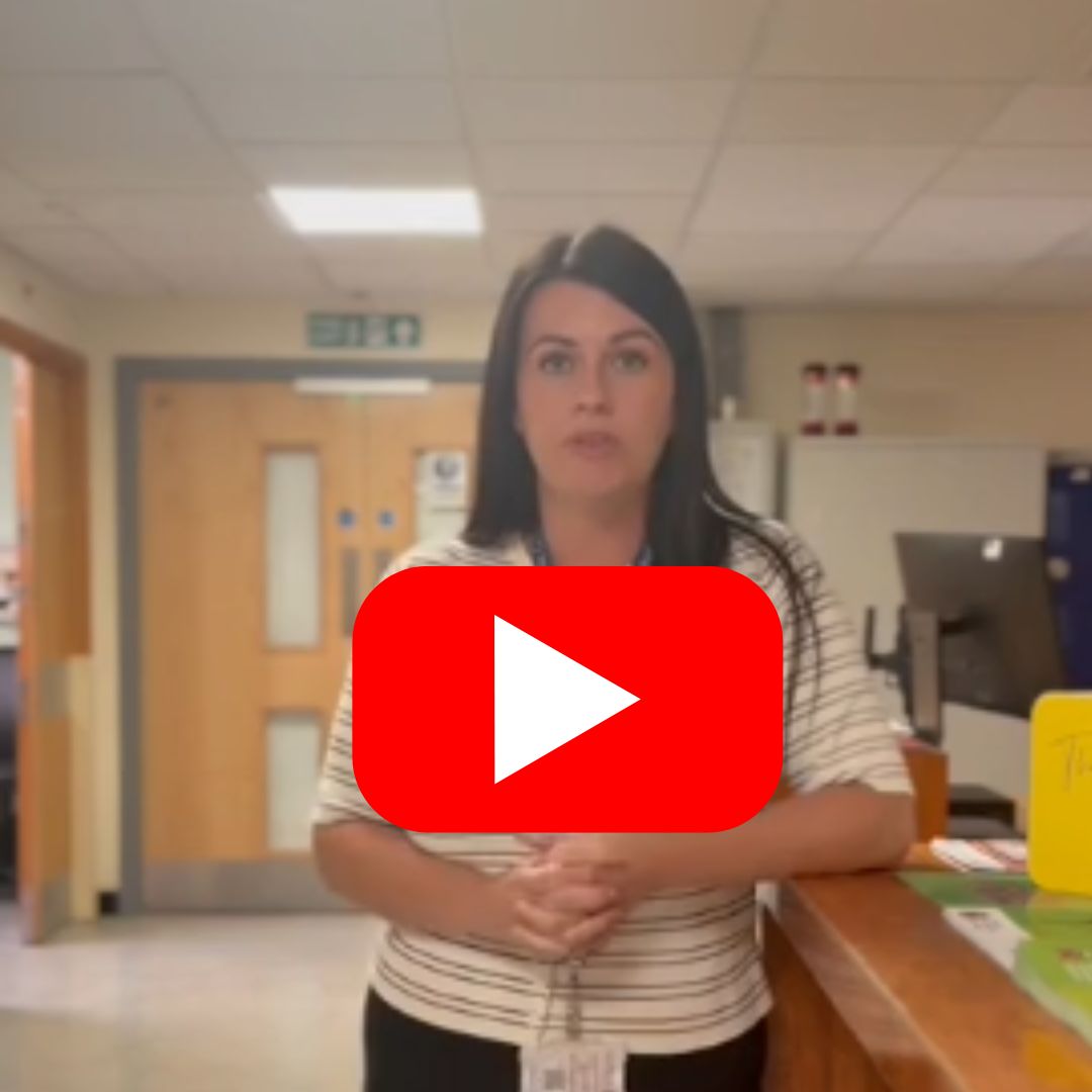 Image of Care Point team member pictured in a hospital setting with a red youtube play button in centre