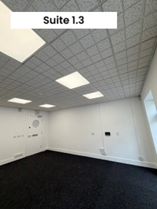 Empty room with lights and grey carpet