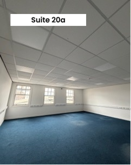 Empty room with three windows and carpet