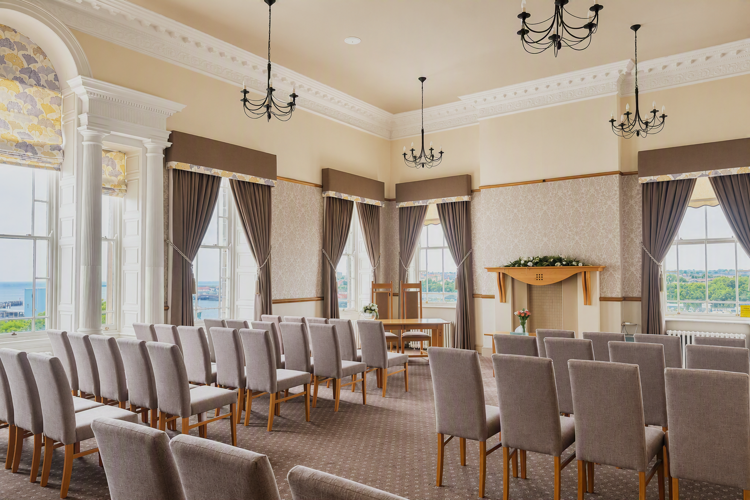 A bright room with rows of chairs set up for a wedding