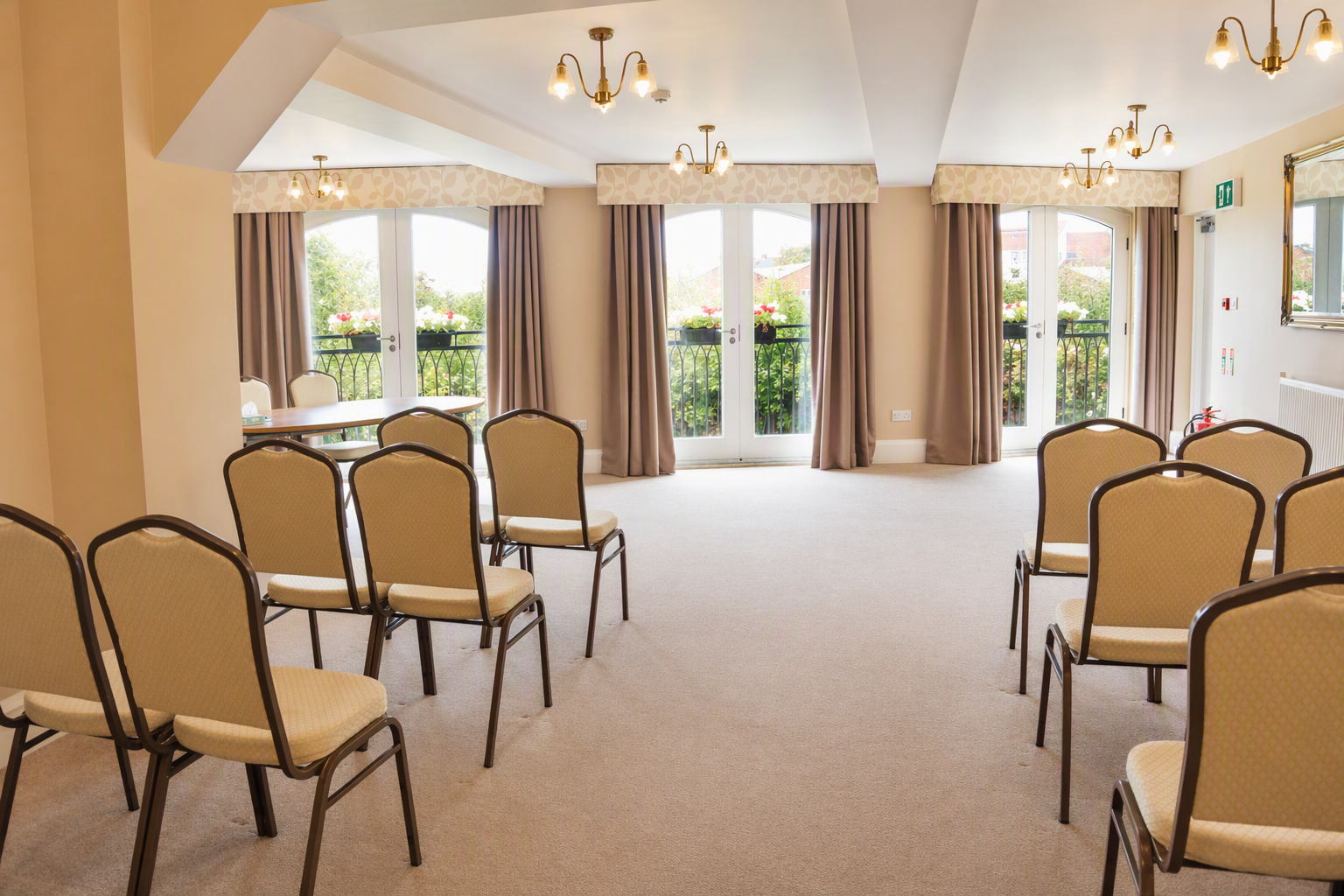 A bright room with rows of chairs lined up for a wedding