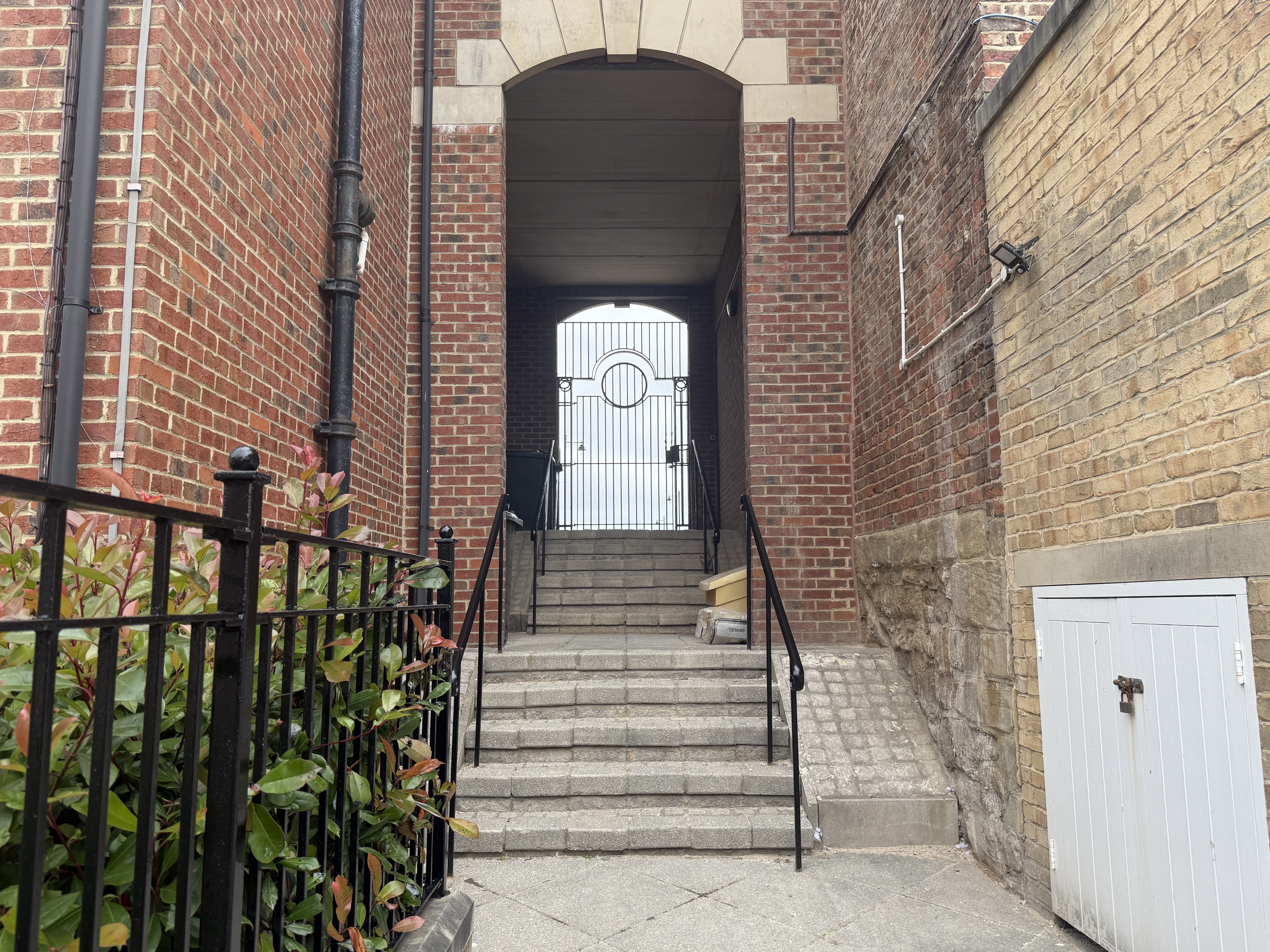 A staircase leading up to an arched doorframe