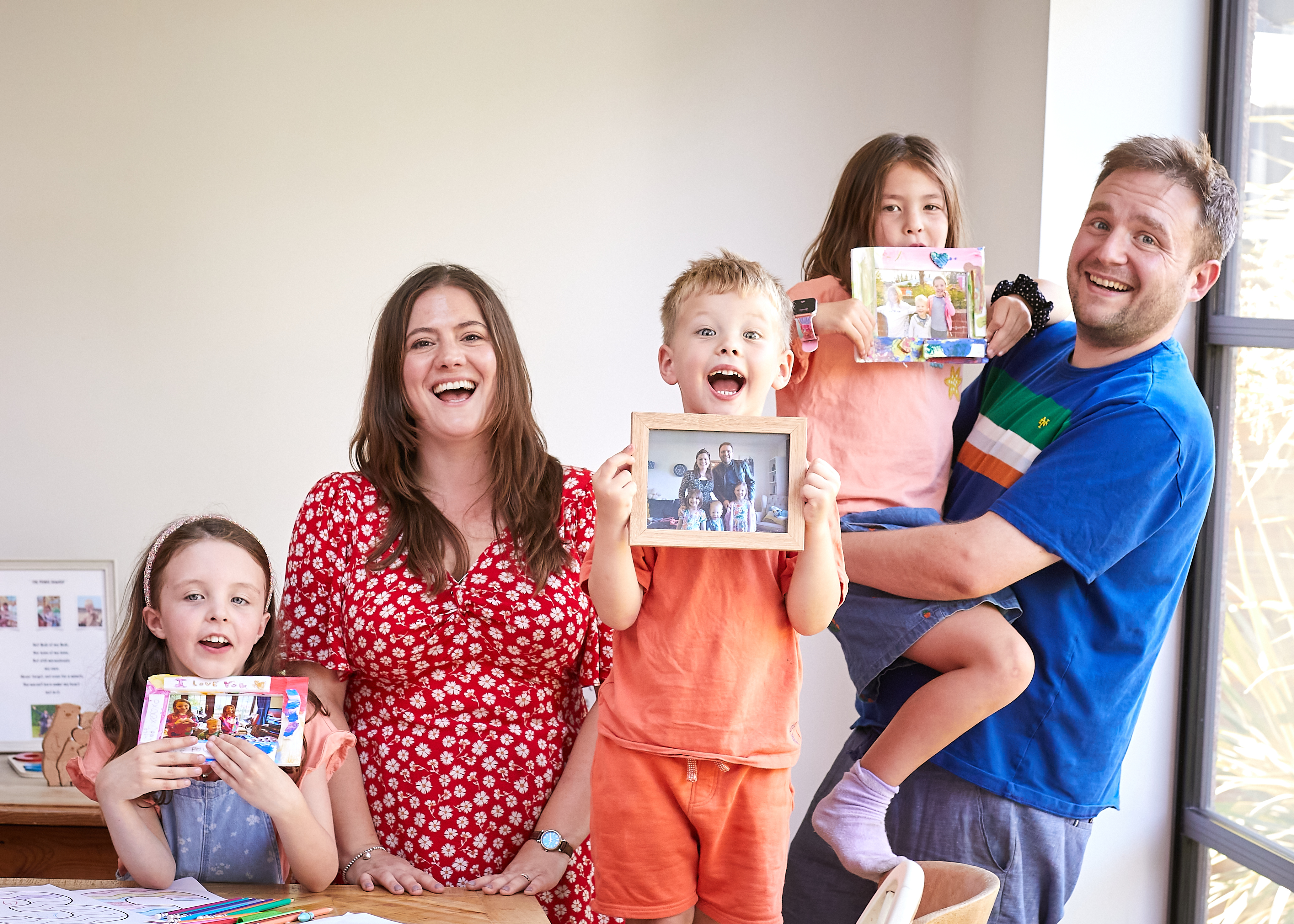 Ed and Annabel with their three children, who they adopted together as a sibling group.