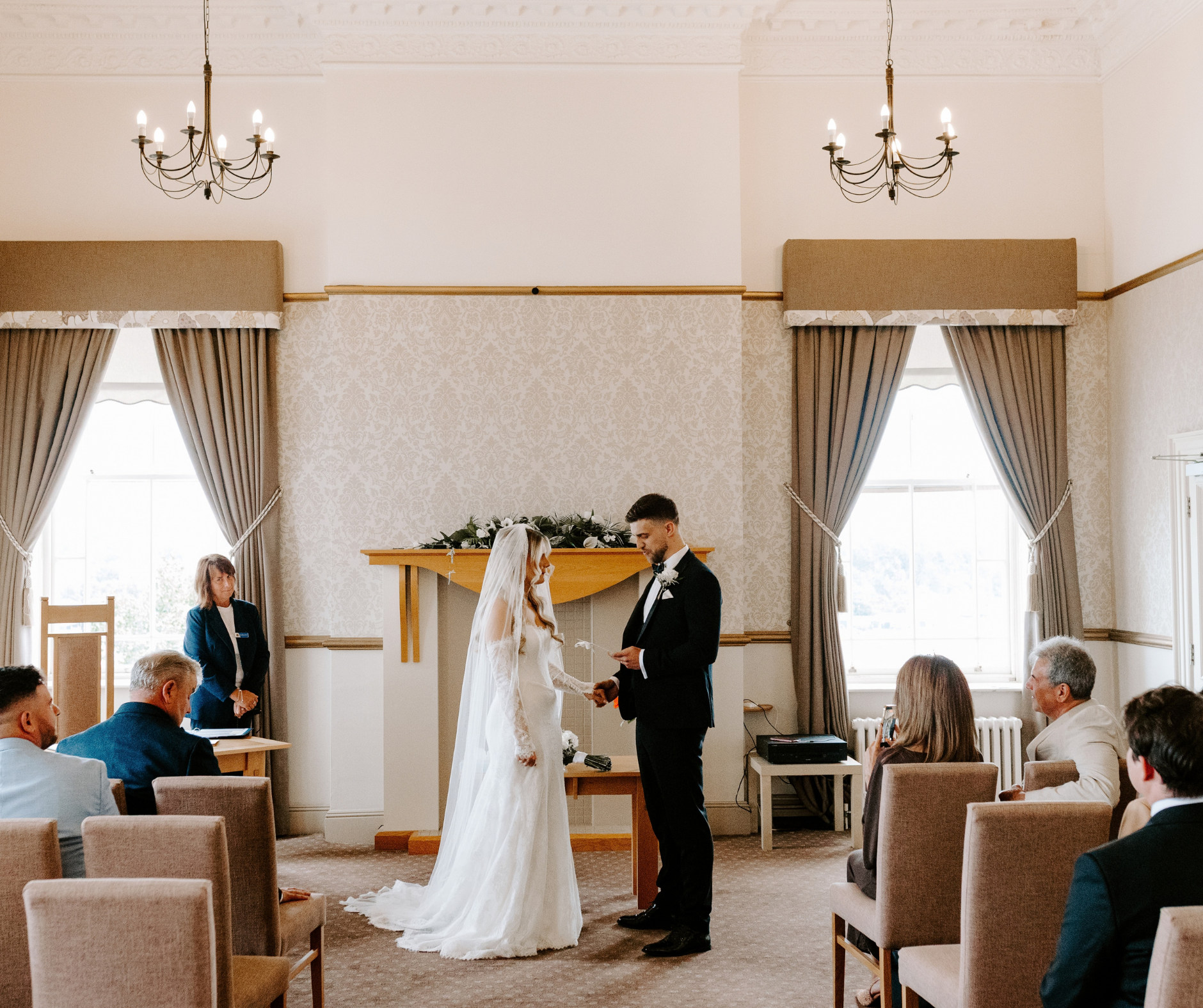 A bride and groom stand in the tyne view room of the maritime chambers 