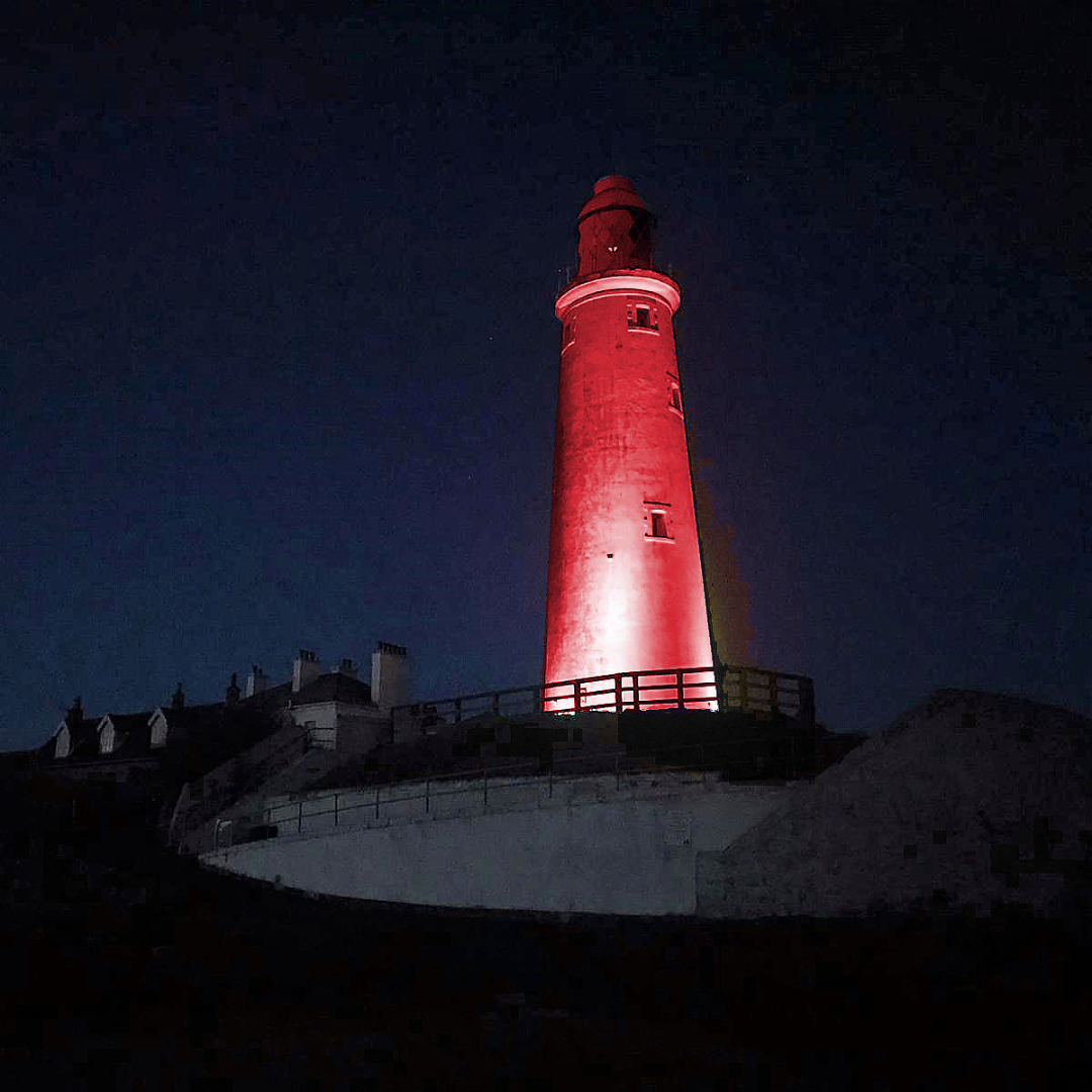 St Mary's Lighthouse at night lit up in red