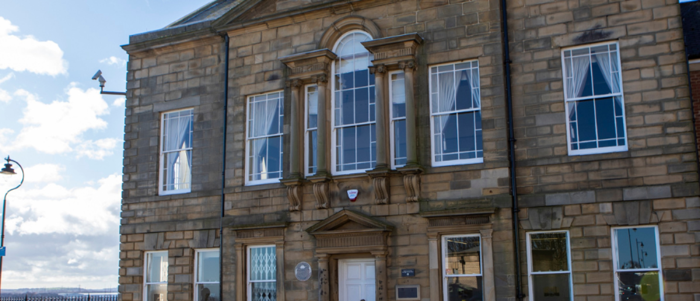 Old stone building with white car outside