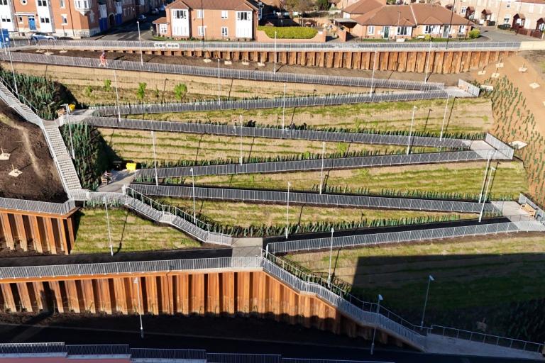 An aerial photo of the Riverside Embankment walkway, a series of zigzag footpaths leading up a steep bank with flights of stairs on the left hand side