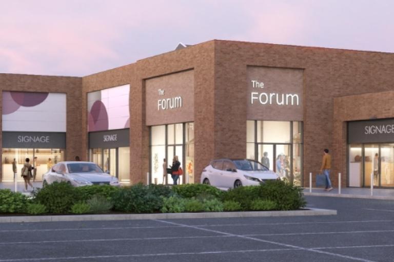 A CGI image of the Forum and an open space outside, with a car park, shrubbery and shoppers walking around