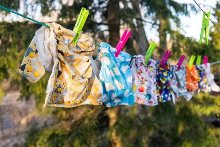 multi coloured cloth nappies hanging on a washing line