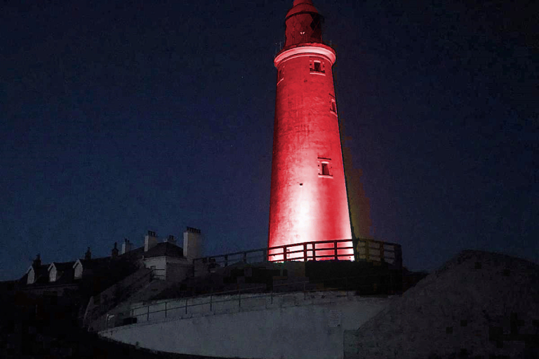 St Mary's Lighthouse at night lit up in red