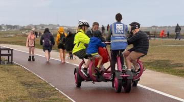 Multiple people on an adapted bike at Whitley Bay