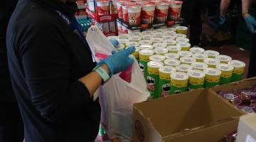 Person packing groceries at food bank
