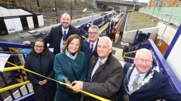 A group of people standing at Northumberland Park metro station at the official opening. 