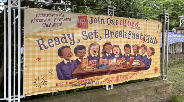 Banner pictured outside the school showing Readfy, Set, Breakfast Club logo