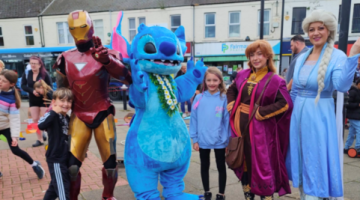 Image of people in character costumes and children