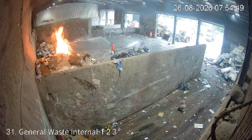 Image shows large fire in the corner of the waste transfer station at the tip 