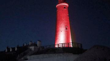 St Mary's Lighthouse at night lit up in red
