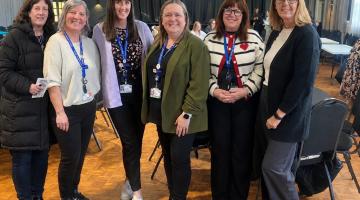 The six Portage Team members pictured together at a conference
