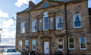 Old stone building with white car outside