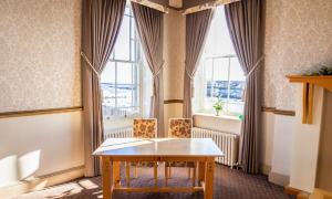 table in a window with curtains