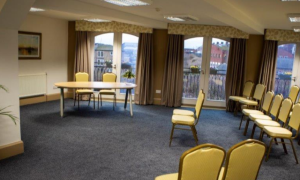 chairs in a room pointing towards a desk