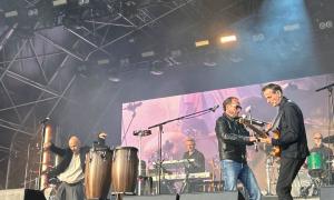 Artists performing under the vibrant Mouth of the Tyne stage lights.