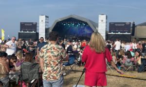 A man and a woman gazing, from a distance, upon the great stage.