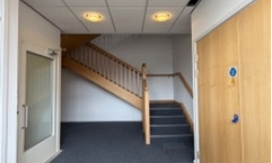Large corridor with staircase and doors