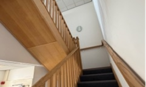 Staircase with wooden bannister