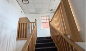Staircase with wooden bannister