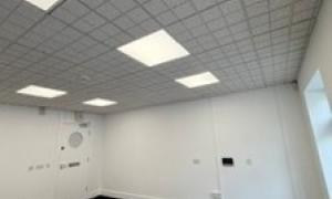 Empty room with lights and grey carpet