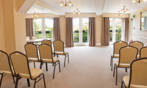 A bright room with rows of chairs lined up for a wedding