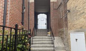 A staircase leading up to an arched doorframe