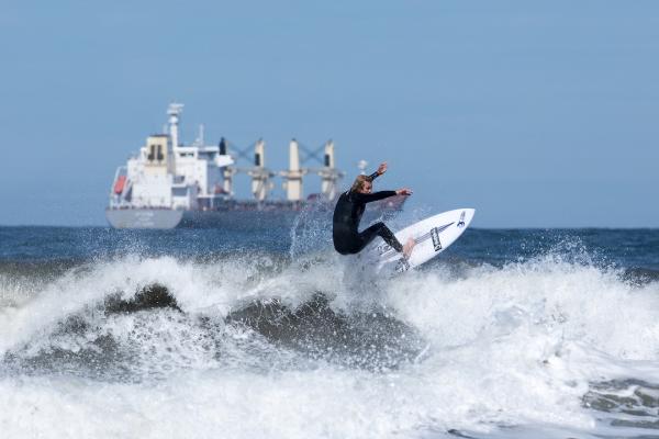 Surfer on the sea at Tynemouth wearing a full wet suit
